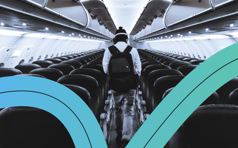 A person walking in the aisle between rows of seats on an airplane, overlaid with a strip of blue color.